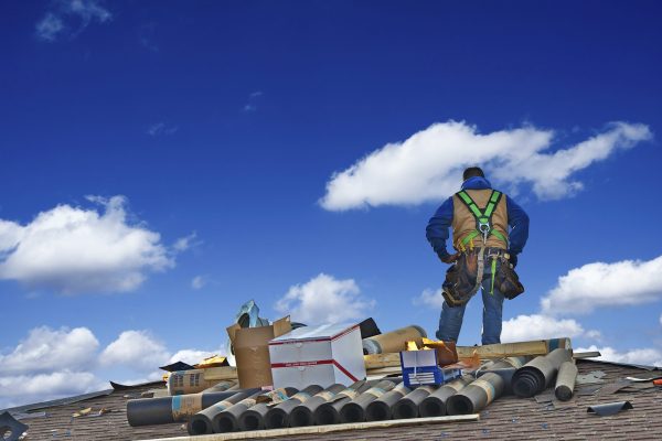 Construction Roofer Carpenter Worker on a Roof Preparing to Work.